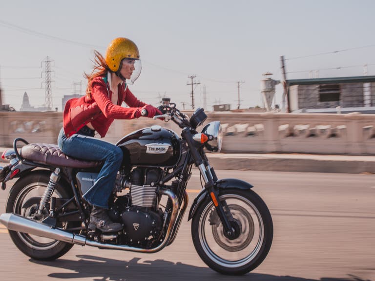 Motorcycle expert Irena Murphy crosses a bridge in Downtown L.A.