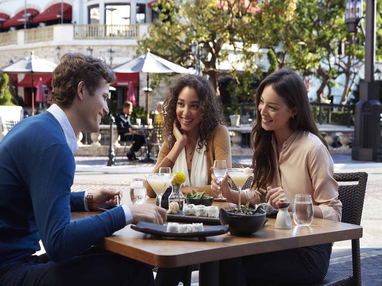 Two girls and a guy dining at The Grove
