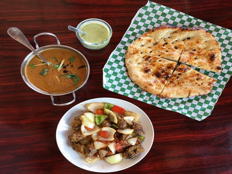 Chicken seekh kebab, haleem, and roghani bread at Zaiqa Grill in Downey